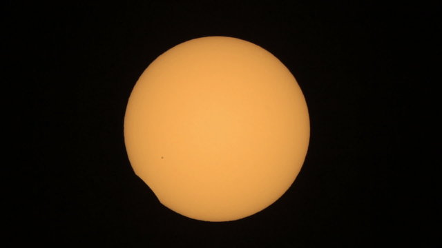 Sun eclipse from the 20.03.2015. - Moon silhouette exiting sun disk. Taken trough my telescope with 1000mm focal length. In the lower left center can be seen a group of sunspots.