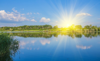 Calm beautiful rural landscape with a lake 