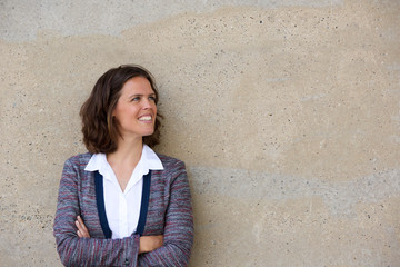 Smiling business woman standing with arms folded