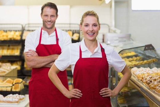 Portrait of two bakers with hands on hips