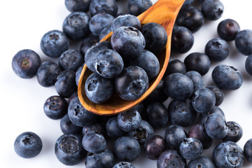 Fresh blueberries in wooden spoon