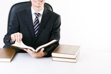 重厚な本を読むビジネスマン