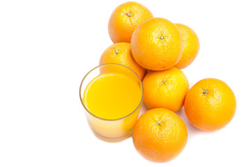Fizzy orange juice from effervescent tablet with oranges at backdrop