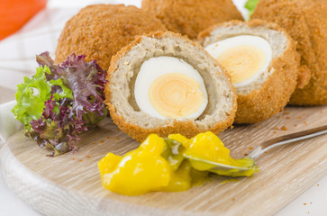 Scotch Egg - Hard-boiled egg wrapped in sausage meat, coated in breadcrumbs and deep-fried.
