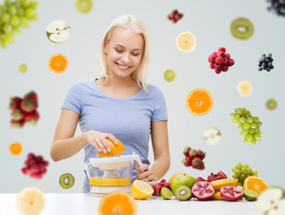 smiling woman squeezing fruit juice at home