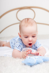 Nice little boy  plaing with soft toy