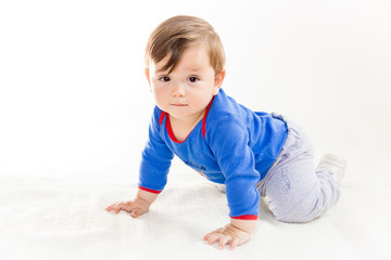 Cute baby boy in diapers crawling on the floor, playing and smiling on an isolated white,...