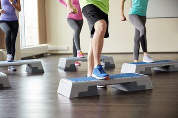group of people flexing legs on step platforms © Syda Productions