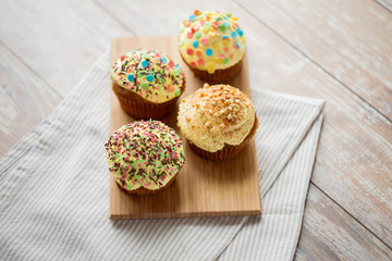 close up of glazed cupcakes or muffins on table
