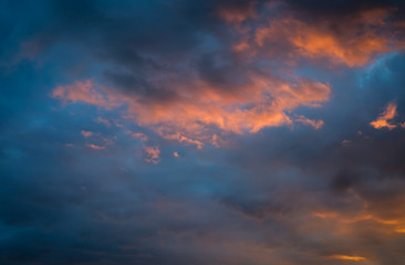 Fototapeta na wymiar Dramatic sunset sky with orange colored clouds.
