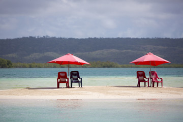 Four chairs and umbrella on tropical beach, venezuela