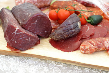 smoked meat products, vegetables on the table