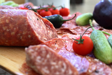 smoked meat products, vegetables on the table