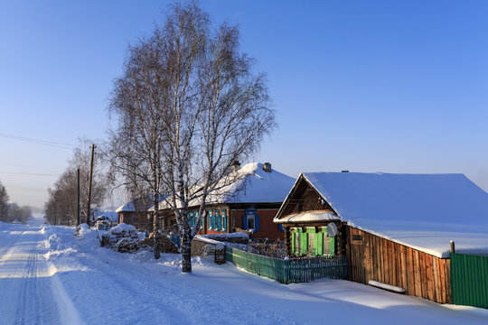 Russian wooden houses in the winter. Village Visim, Ural, Russia