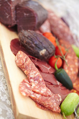 smoked meat products, vegetables on the table