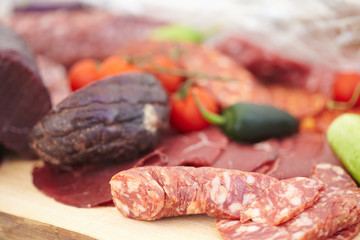 smoked meat products, vegetables on the table