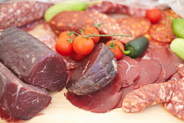 smoked meat products, vegetables on the table