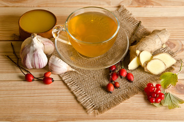 Cup of tea,slices of ginger,honey,rosehip berries and viburnum o