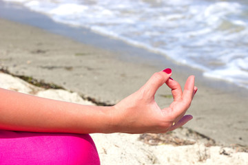 Fototapeta na wymiar Young woman is doing exercises yoga on the seashore,Photography