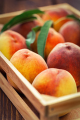 Fresh peaches in a wooden basket