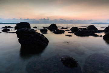 Seascape with stone at sunrise.