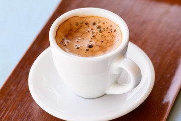 Fototapeta premium Hot espresso in white cup on wooden tray.
