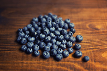 Fresh great bilberries on wooden ground