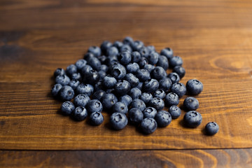 Fresh great bilberries on wooden ground