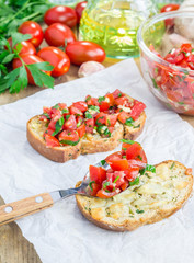 Bruschetta with tomatoes, herbs and oil on toasted garlic cheese bread
