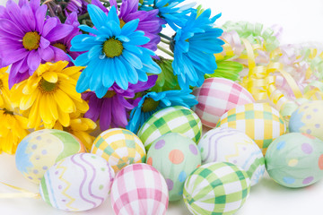 Easter Flowers and Eggs – Brightly colored daisies with decorated eggs for Easter.