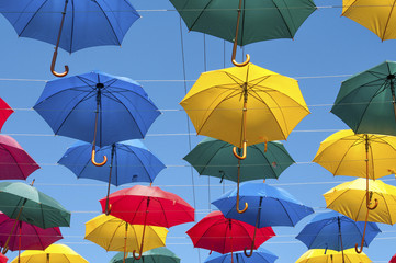 Fototapeta na wymiar Bright umbrellas in the street