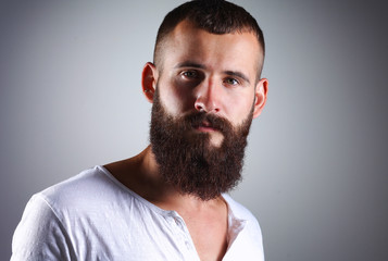 Obraz premium Portrait of handsome bearded man standing, isolated on grey