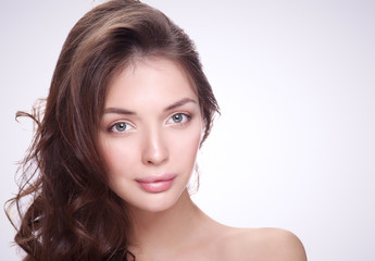 Fototapeta premium Close up portrait of beautiful young woman face. Isolated on