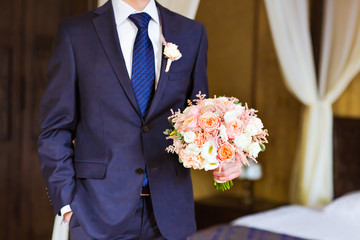 the groom with   bouquet