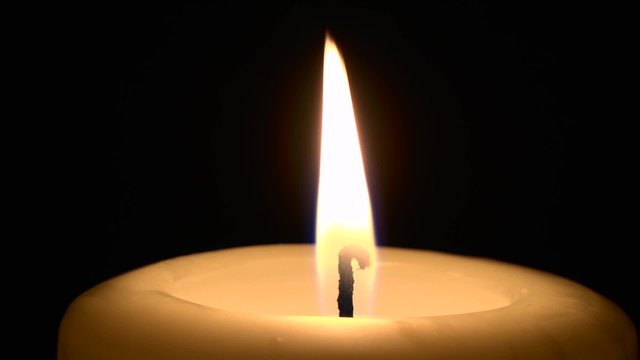 Flickering Single Candle On Black Background