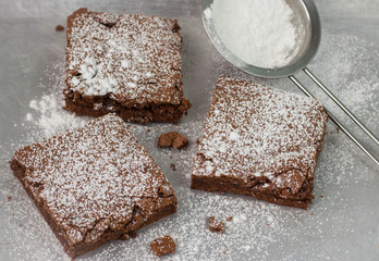 Brownie. Chocolate cakes with powdered sugar