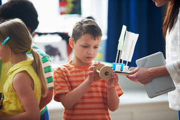 Group Of Children Carrying Out Experiment In Science Class