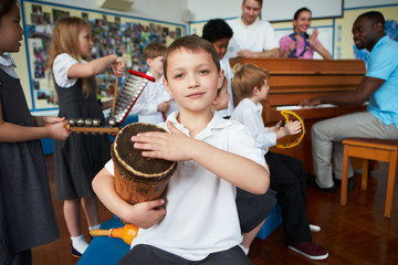 Group Of Children Playing In School Orchestra Together