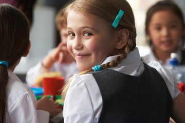 Girl Eating Healthy Packed Lunch In School Cafeteria