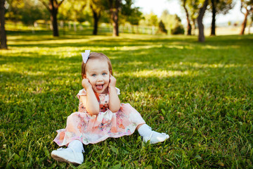 Cute little girl on the meadow in summer day.