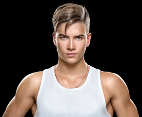 Handsome athletic young man isolated on black background