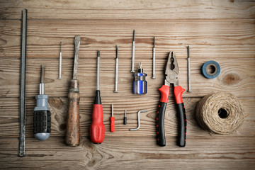 set of work tools on a wooden table in a row. horizontal