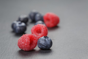 closeup photo of fresh organic raspberries and blueberries