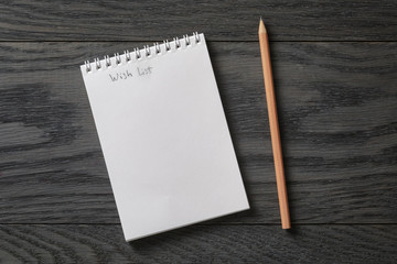simple blank notepad with phrase wish list on rustic wood table