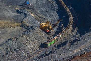 excavator loads the ore carriages