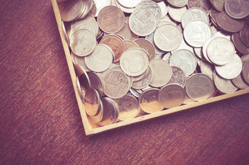 coins on wood with filter effect retro vintage style