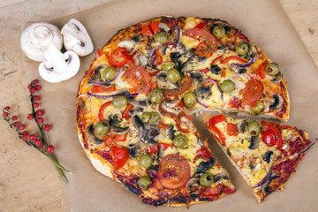 homemade pizza with olives, mushrooms and paprika