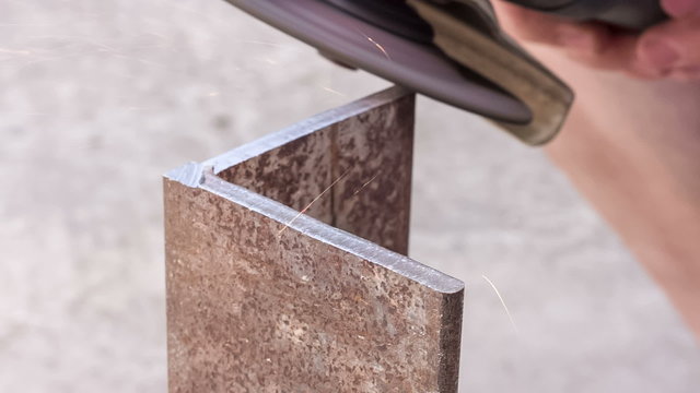 Processing sharp edges on the metallic article with a grinding wheel 