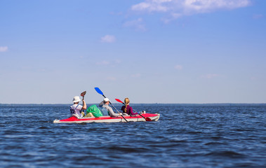 Young people are kayaking on a river in beautiful nature