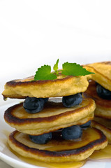 Delicious pancakes close up, with fresh blueberries and maple syrup